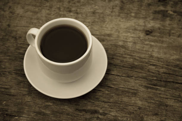 istock Cup of coffee on wooden table 843920400