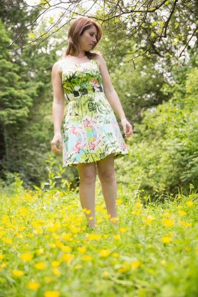 istock Cute young woman standing in field 843921362