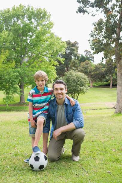 istock Father and son with ball at the park 843921812