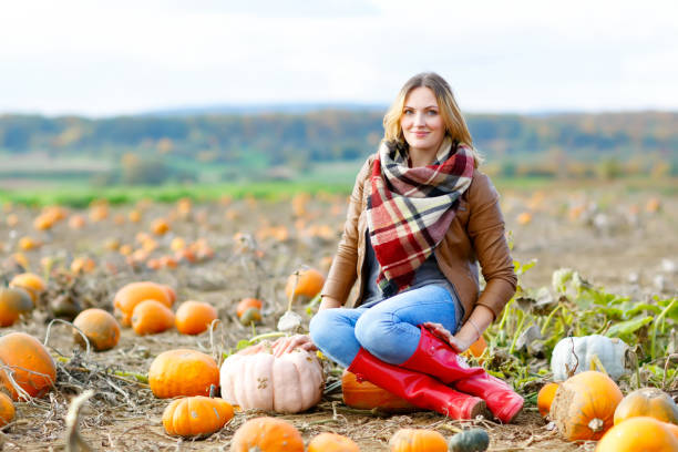 istock Beautiful woman working on pumpkin field 843921984