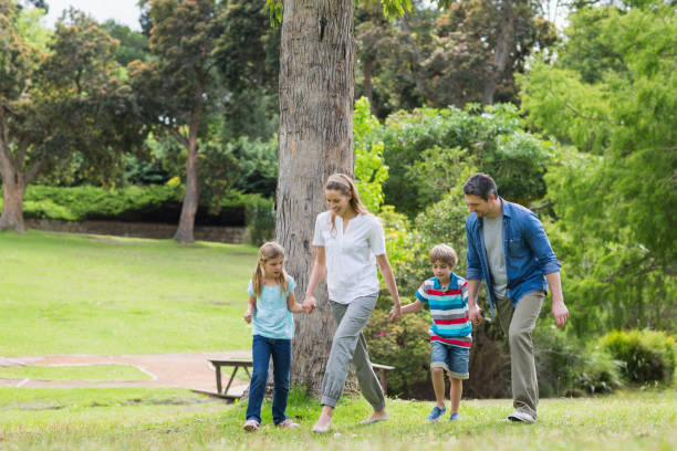 istock Parents and kids walking in park 843922016