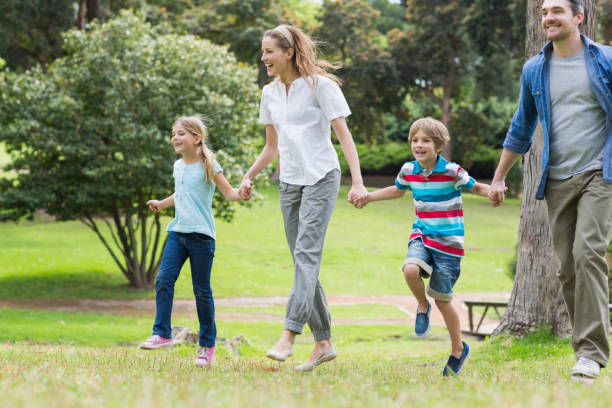 istock Parents and kids walking in park 843922038