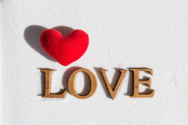 istock Love on white sand background with red heart 843928100