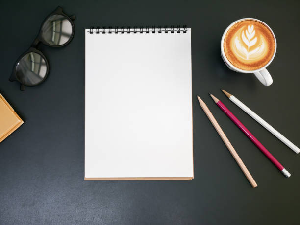 istock Blank notepad pencil on office desk with coffee cup ,top view 843931296