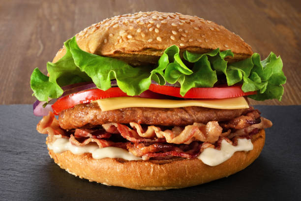 istock Home made hamburger with lettuce, cheese and bacon. 843939162