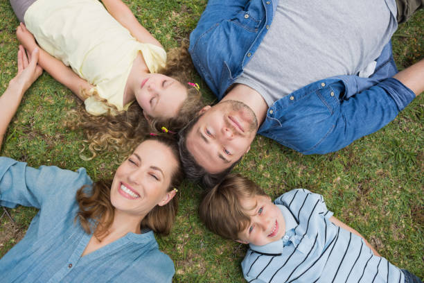 istock Happy parents and kids lying at park 843941582