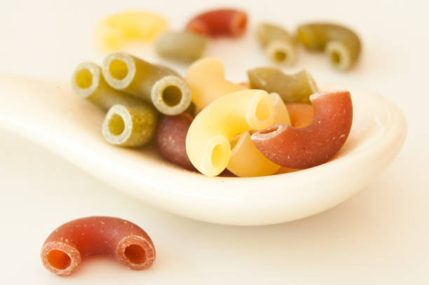 istock colorful pasta in a spoon on white background 843942948