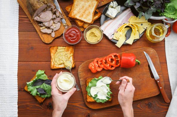 istock the hostess prepares a sandwich on a wooden table for guests 843949912