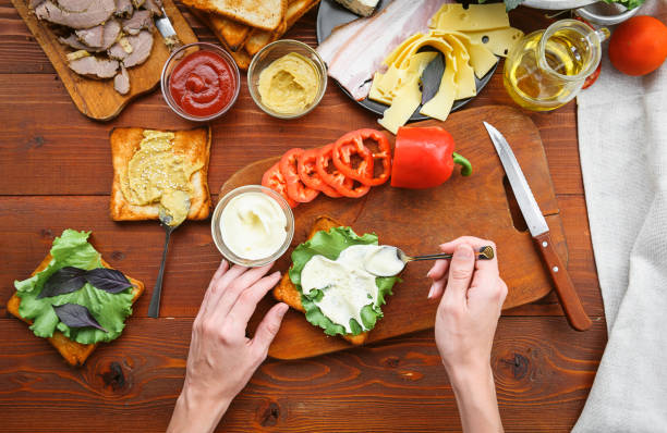 istock the hostess prepares a sandwich on a wooden table for guests 843949928