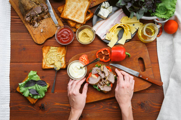 istock the hostess prepares a sandwich on a wooden table for guests 843949966