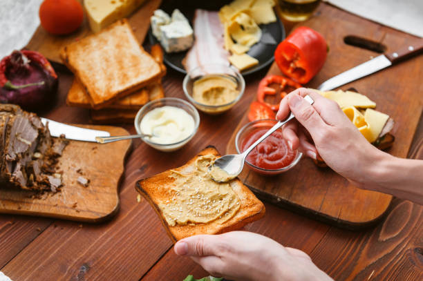 istock the hostess prepares a sandwich on a wooden table for guests 843950022