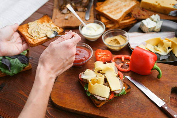 istock the hostess prepares a sandwich on a wooden table for guests 843950028