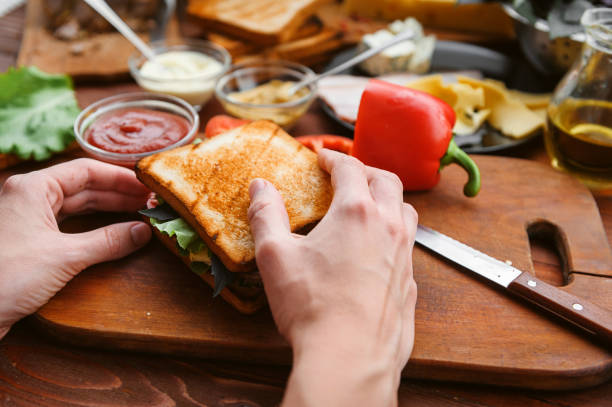 istock the hostess prepares a sandwich on a wooden table for guests 843950084