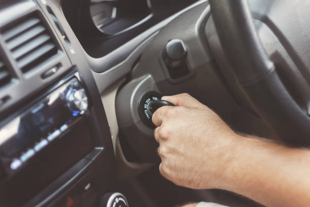istock man's hand starts a car with the key in retro toning 843951620