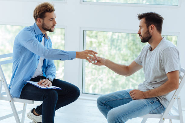 istock Cheerless depressed man taking a glass of water 843951868