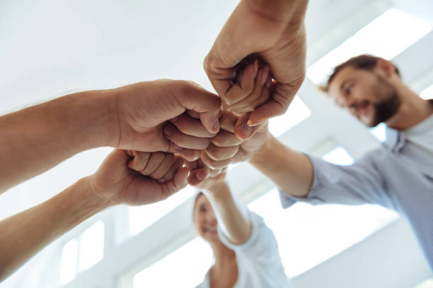 istock Close up of fists being held together 843963392