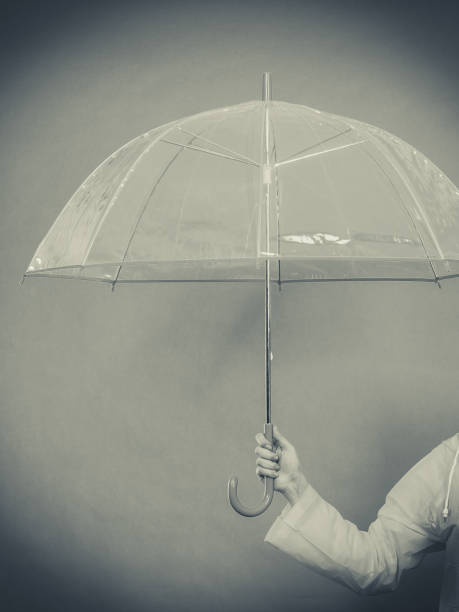 istock Woman hand holding transparent umbrella 843965926