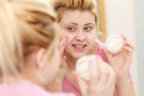 istock Woman applying face cream with her finger 843966672