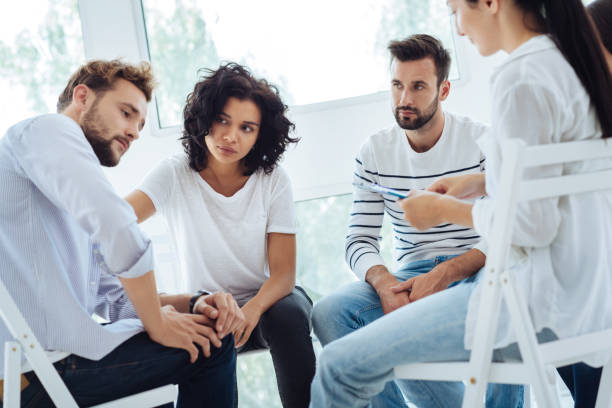 istock Unhappy cheerless people having a group session 843969136