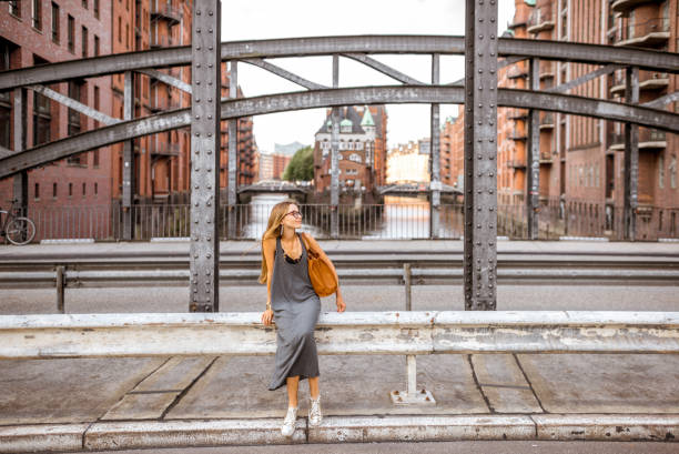 Beautiful iron bridge with woman walking in Speicherstadt, historic warehouse district in Hamburg, Germany