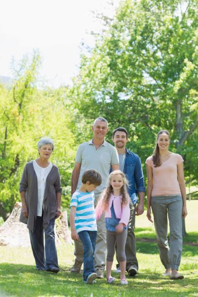 istock Happy extended family walking in park 843973056
