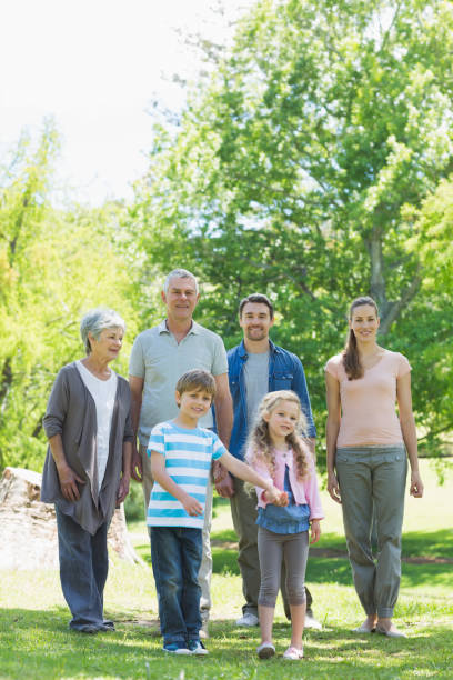 istock Happy extended family walking in park 843973084