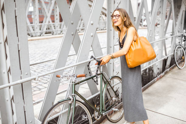 istock Woman with bicycle on the iron bridge 843976234