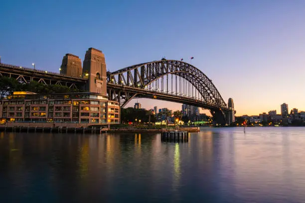 A beautiful dawn in Sydney, this is the view looking across the waters of Sydney Harbour towards the city's iconic Harbour Bridge.