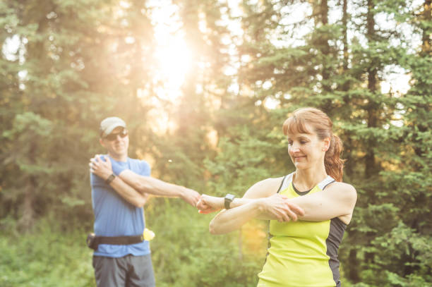 istock Two mature adults trail running in the forest 843977200