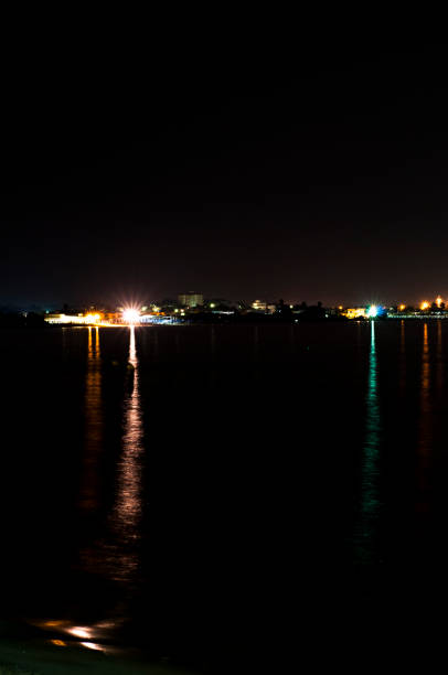 istock street lights at night on the sea 843978050
