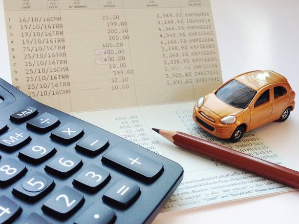 istock Miniature car model, calculator and saving account book or financial statement on office desk table 843979056