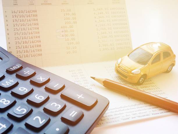 istock Miniature car model, calculator and saving account book or financial statement on office desk table 843979290