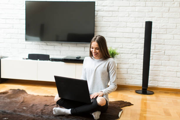 istock Woman with laptop at home 843983304