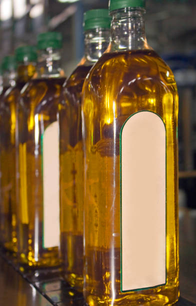 istock Bottling plant, row of plastic bottles with olive oil inside. 843990508