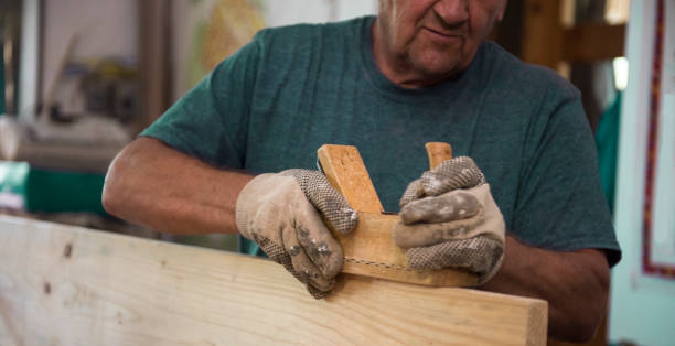 istock Senior carpenter planing wood 843993672