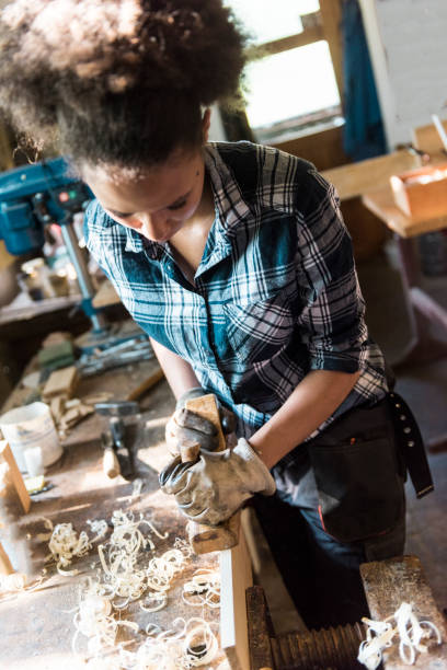 istock Female carpenter planing wood 843993698