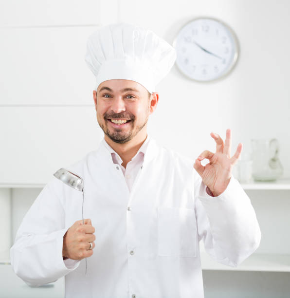 istock Positive young cook holding soup ladle 844000094