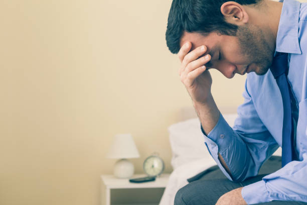 istock Sad man sitting head in hands on his bed 844012448