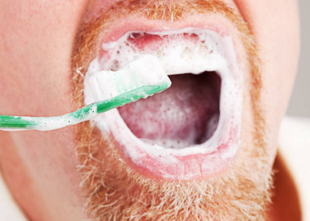 istock Close-up of bearded man energetically brushing his teeth 844012888