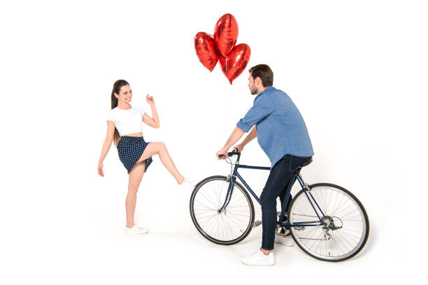istock couple with bicycle and balloons 844016570