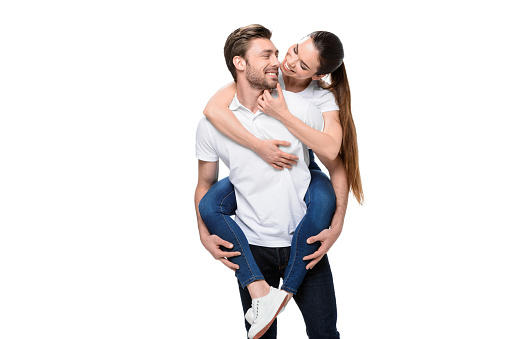 A man and a woman standing back to back on white background