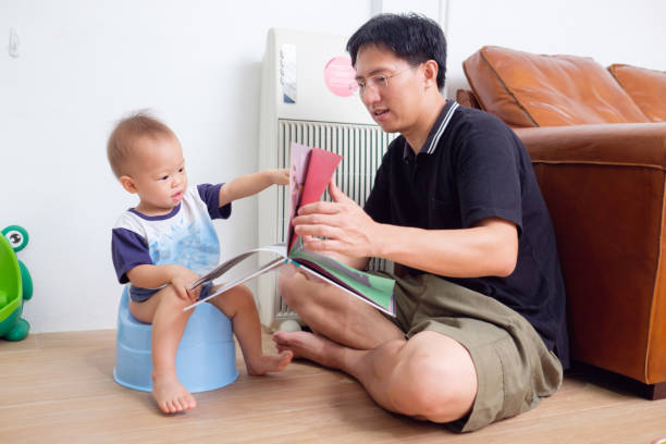 Father Training His Son to Use Potty, stock photo