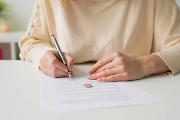 Woman going through divorce and signing papers