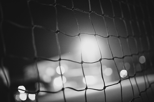 Soccer goal. Football goal. Night. Lights. Long exposure. Black and white.