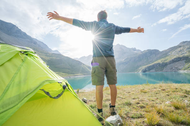 istock Young man enjoying camping in the wild 844031352
