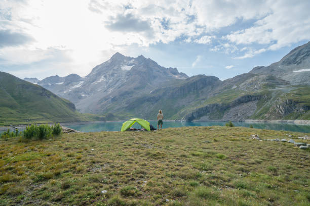 istock Young woman enjoying camping in remote area 844031422