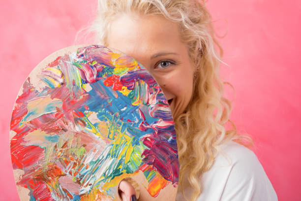 Artist hiding behind paint palette