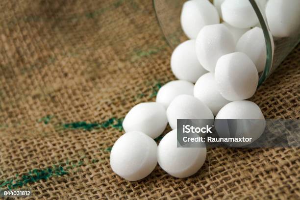 Moth Balls In The Glass Over The Sackcloth Stock Photo - Download Image Now - Sphere, Moth, Naphthalene