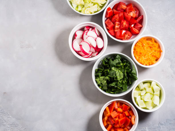 Mix of vegetable bowls for salad or snacks Mix of vegetable bowls for salad or snacks on gray background. Diet detox concept chopping food photos stock pictures, royalty-free photos & images