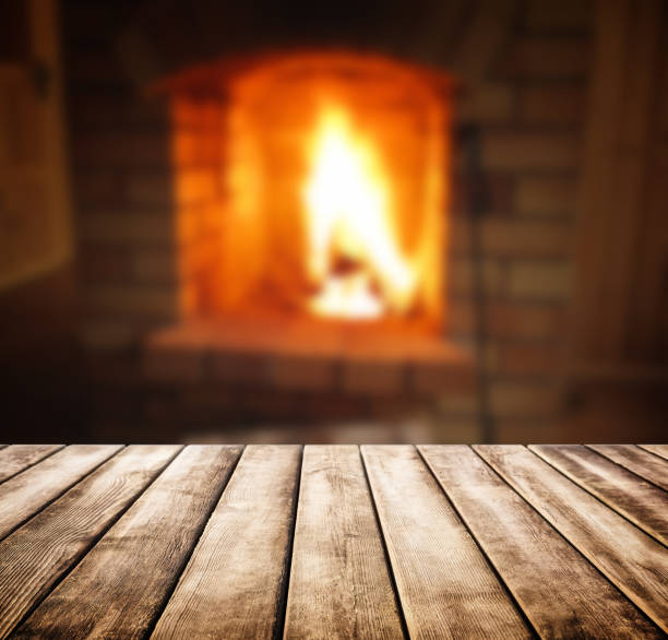istock Old wooden table and blurred of fireplace 844037208